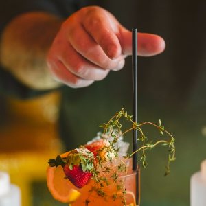 Finishing The Strawberry Thyme Cocktail With a Straw