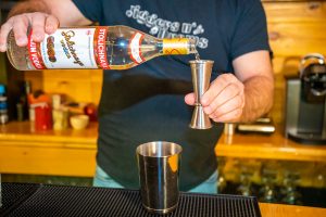 Pouring Stolichnaya vodka into the shaker